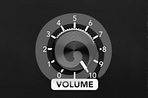 Volume control knob of a black amplifier on maxiumum loudness