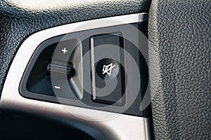 The volume control on the steering wheel of the car