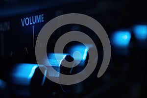 Volume knob on amplifier with cool blue light