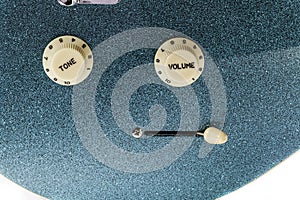 Volume and tone controls on glam rock electric guitar