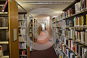 Volumes of books on bookshelf in library