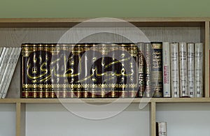 Volumes of Islamic religion books placed on a shelf of a school library