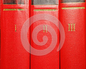 Volumes of old books with gold lettering on the cover