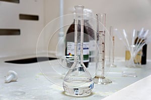 Volumetric flask and cylinder are placed in the fume hood of the chemical laboratory. ExpeVolumetric riment in Science laboratory.
