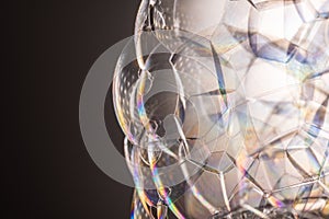 Voluminous ball of transparent rainbow soap bubbles with a beautiful gradient to the left