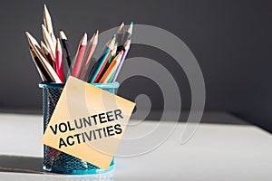 Volunteer activities - text on paper stickers with colorful pencils