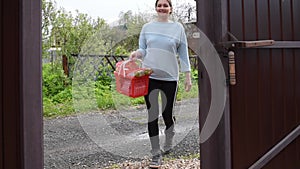 Volunteer brought a basket of groceries for woman home. Donation to old woman