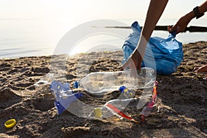 Volunteer Cleaning Polluted Beach Picking Up Plastic Trash Outdoors, Cropped