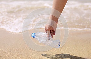 Volunteer collect trash, plastic garbage bottles on the beach. Ecology, environment, pollution and ecological problems concept