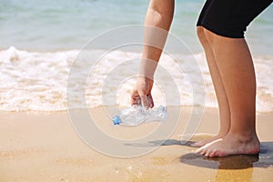 Volunteer collect trash, plastic garbage bottles on the beach. Ecology, environment, pollution and ecological problems concept