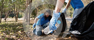 Volunteer collecting plastic trash in the forest. The concept of environmental conservation. Global environmental