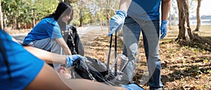 Volunteer collecting plastic trash in the forest. The concept of environmental conservation. Global environmental