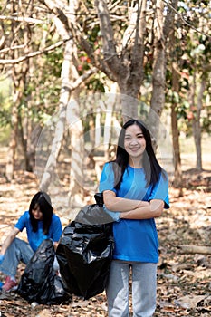 Volunteer collecting plastic trash in the forest. The concept of environmental conservation. Global environmental