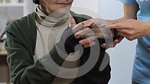 Volunteer giving plate with food for homeless woman in care center, charity