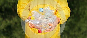 Volunteer hands holding bottle plastic garbage. Environment clean up park cleaning trash nature. Volunteer cleaning