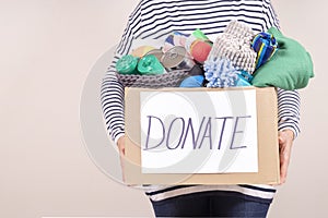 Volunteer holding donation box with animal food, pet goods and supplies for animal shelters