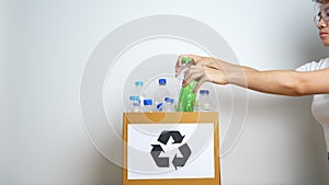 Volunteer keep plastic bottle into paper box at home or office. Hand Sorting Recycle garbage. Ecology, Environmental, pollution,