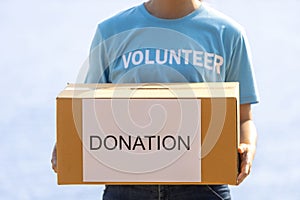 Volunteer people is holding box of money raising donation in the charity work and ngo related activity such as global warming,