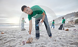 Volunteer portrait, beach cleaning or man for recycling plastic bottle for community service, pollution and earth day