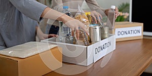 Volunteer preparing free foodstuff rations for poor people. Charity two woman of the community work together. concept of