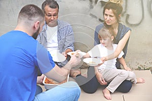 Volunteer serving food for poor people