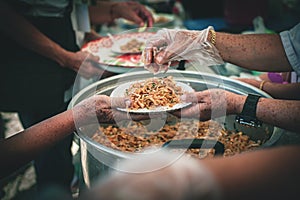 volunteer serving food to the homeless in the Community Charitable Donation Center Concept of free food assistance service