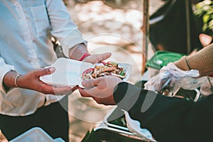 volunteer serving food to the homeless in the Community Charitable Donation Center Concept of free food assistance service