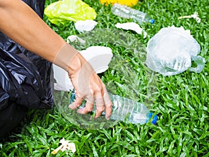 Volunteer spirit with conserving and preserving environment by garbage collection Plastic water bottle with black bag photo