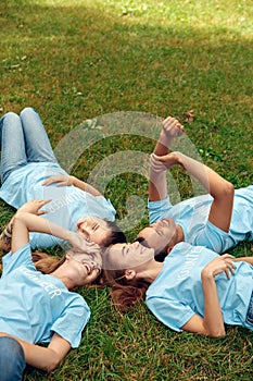 Volunteering. Young people volunteers outdoors lying resting laughing cheerful