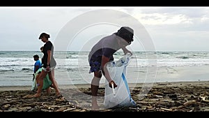 Volunteers clean plastic garbage on the beach. Cleaning the beach from plastic debris. ocean rescue