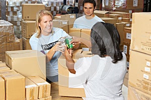 Volunteers Collecting Food Donations In Warehouse photo