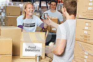 Volunteers Collecting Food Donations In Warehouse photo