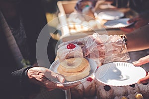 Volunteers donating food to people in a society in need of food: the concept of helping with food