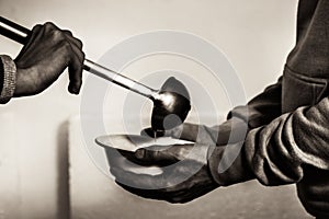 Volunteers feed the homeless. Free soup in a bowl of beggar photo