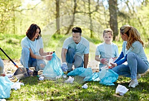 Volunteers with garbage bags cleaning park area