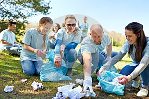 Volunteers with garbage bags cleaning park area