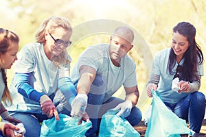 Volunteers with garbage bags cleaning park area