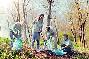 Volunteers with garbage bags cleaning park area