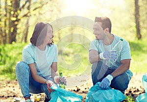 Volunteers with garbage bags cleaning park area