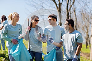 Volunteers with garbage bags cleaning park area