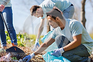 Volunteers with garbage bags cleaning park area