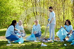 Volunteers with garbage bags cleaning park area