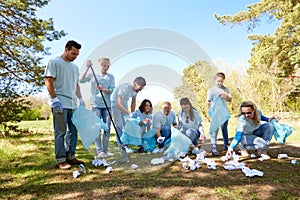 Volunteers with garbage bags cleaning park area