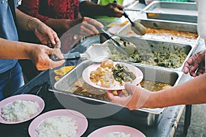 Volunteers giving food to poor people: The concept of food sharing Help solve Hunger for the homeless