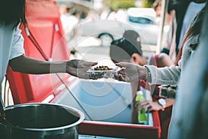 Volunteers giving food to poor people: The concept of food sharing Help solve Hunger for the homeless