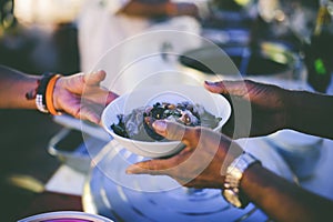 Volunteers giving food to poor people: The concept of food sharing Help solve Hunger for the homeless