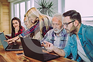 Volunteers help senior people on the computer