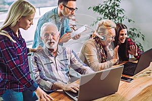 Volunteers help senior people on the computer