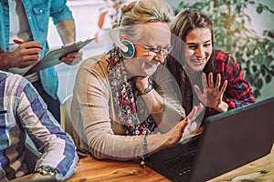 Volunteers help senior people on the computer