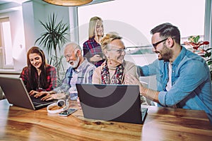 Volunteers help senior people on the computer